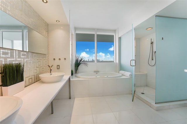 bathroom with independent shower and bath, vanity, backsplash, and tile patterned floors