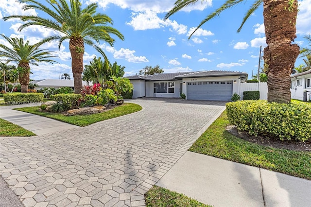 2964 NE 36th St, Lighthouse Point, FL 33064 - single story home featuring a garage, decorative driveway, stucco siding, and a tile roof