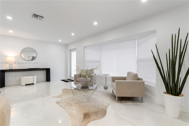 sitting room with recessed lighting, marble tiled flooring, and baseboards