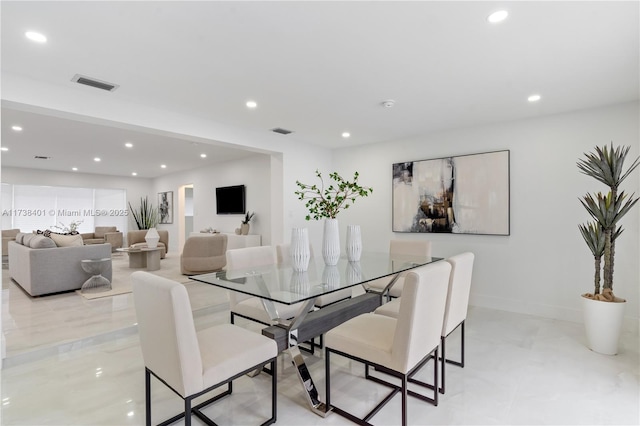 dining room featuring recessed lighting and baseboards