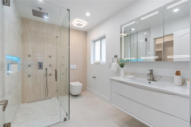 bathroom featuring a stall shower, vanity, toilet, and baseboards