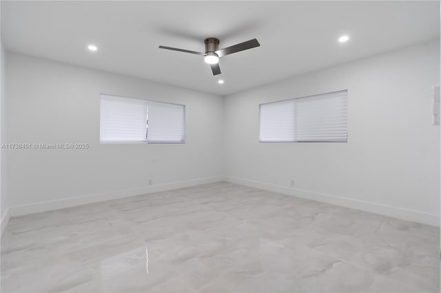 unfurnished room with ceiling fan, recessed lighting, baseboards, and light marble finish floors