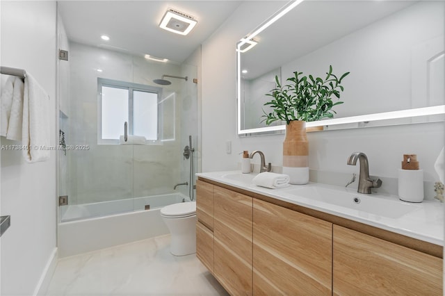 bathroom featuring double vanity, bath / shower combo with glass door, toilet, marble finish floors, and recessed lighting