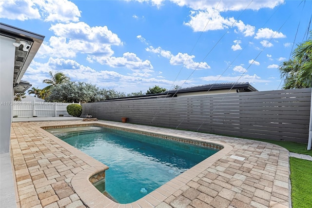 view of swimming pool featuring a patio area