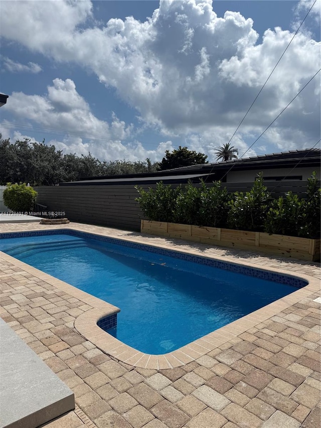 view of swimming pool featuring a patio