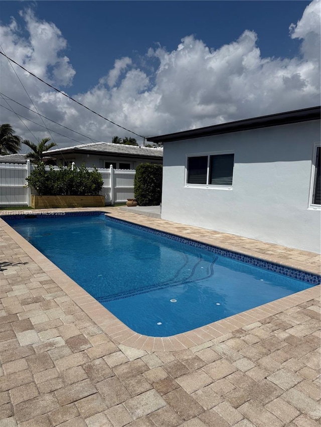 view of pool with fence and a patio