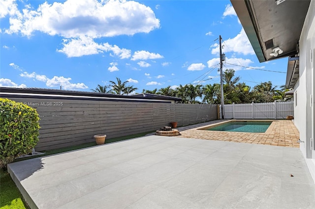 view of patio with a fenced in pool