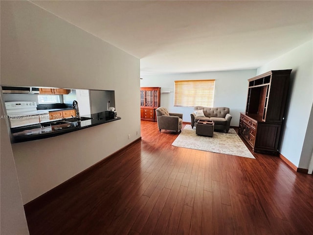 living area featuring dark wood-style floors and baseboards