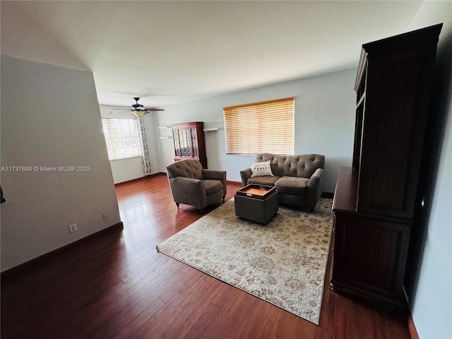 living area with dark wood-style floors and ceiling fan