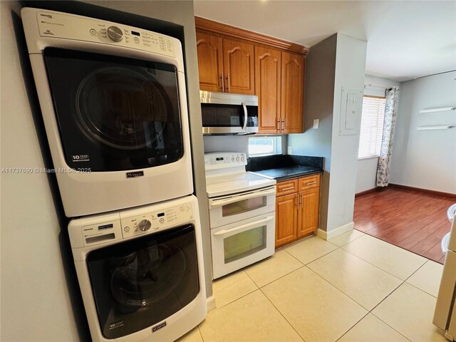 kitchen featuring light tile patterned flooring, white appliances, and sink