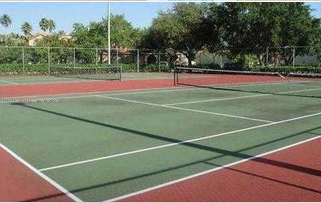 view of sport court featuring fence