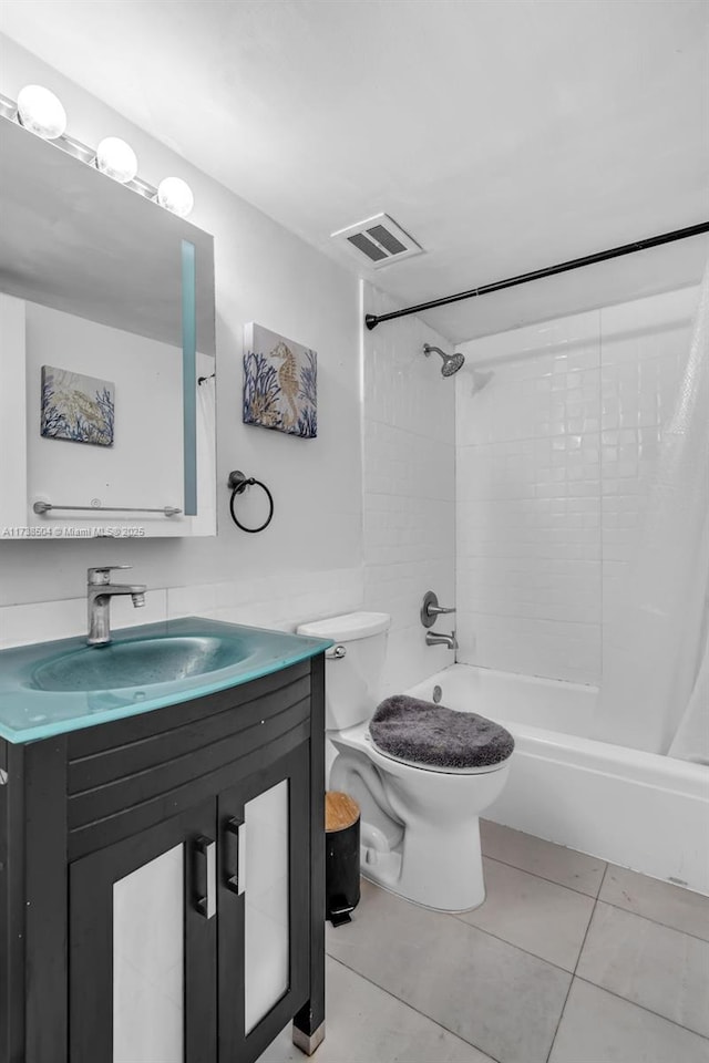 full bathroom featuring tile patterned floors, vanity, toilet, and shower / bath combo with shower curtain