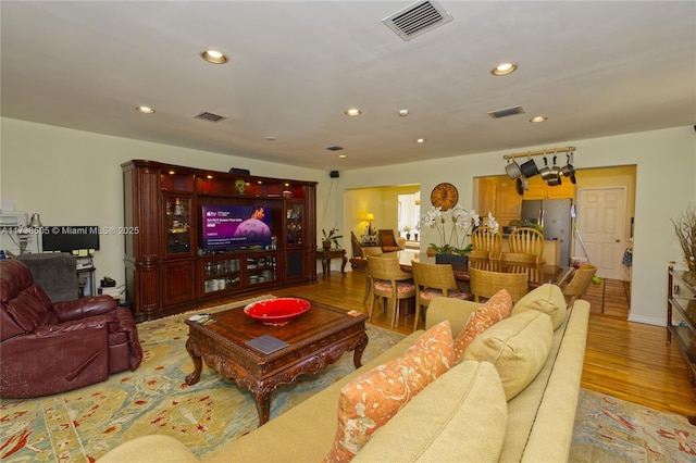 living room with light hardwood / wood-style flooring