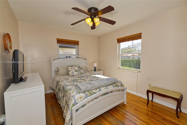 bedroom with dark hardwood / wood-style floors and ceiling fan