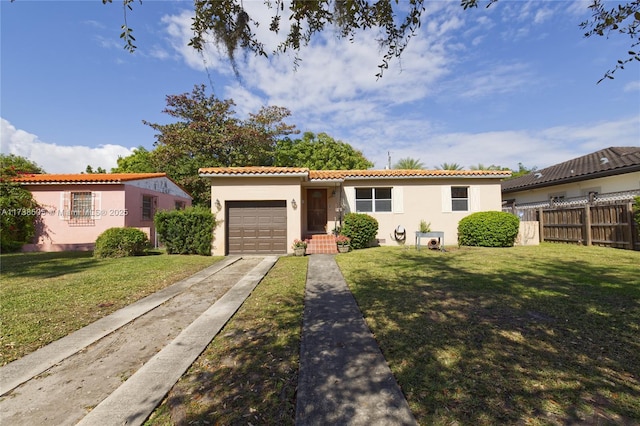 mediterranean / spanish-style home featuring a garage and a front lawn