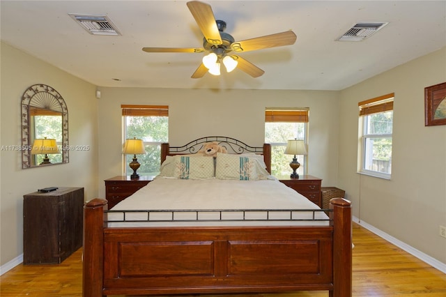 bedroom with light hardwood / wood-style floors and ceiling fan