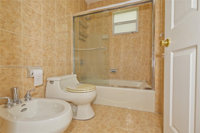 full bathroom featuring sink, combined bath / shower with glass door, tile walls, tile patterned floors, and toilet