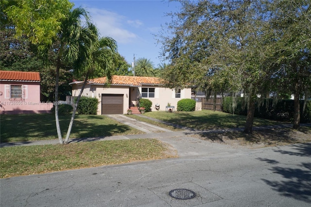 view of front facade with a garage and a front lawn