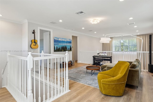 living room featuring ornamental molding and light wood-type flooring