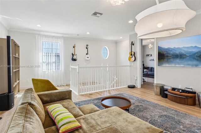 living room featuring ornamental molding, hardwood / wood-style floors, and a wealth of natural light