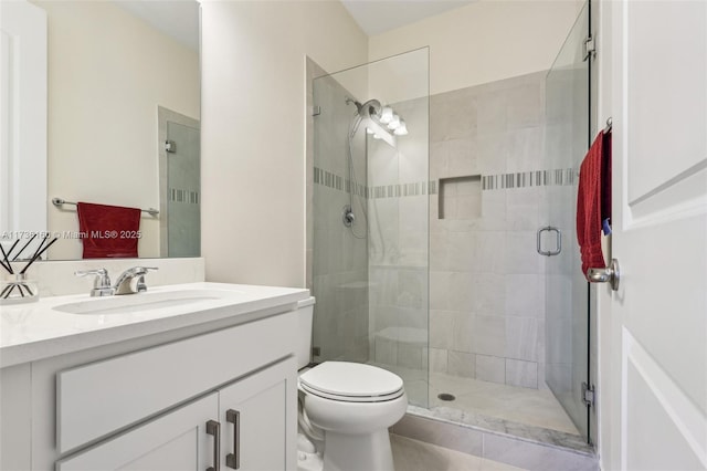 bathroom featuring vanity, toilet, and walk in shower