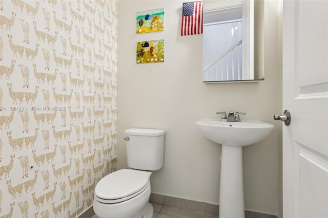 bathroom with a shower with curtain, tile patterned floors, and toilet