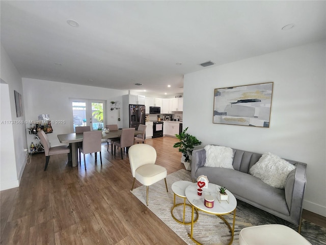 living room with light hardwood / wood-style flooring