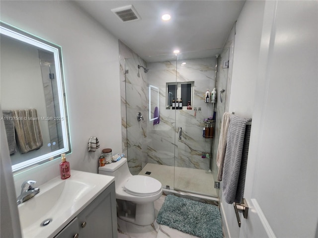 bathroom featuring vanity, an enclosed shower, and toilet