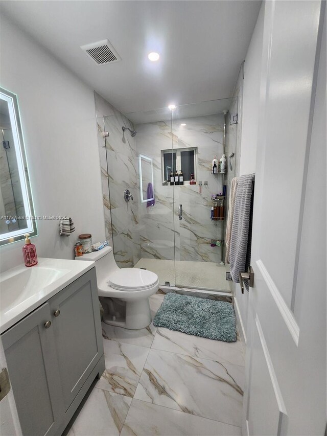 bathroom with vanity, toilet, and an enclosed shower