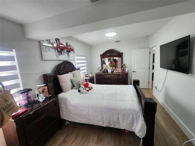 bedroom with hardwood / wood-style floors