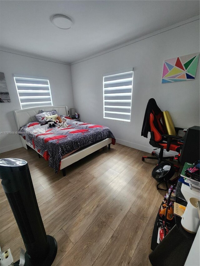 bedroom with hardwood / wood-style floors