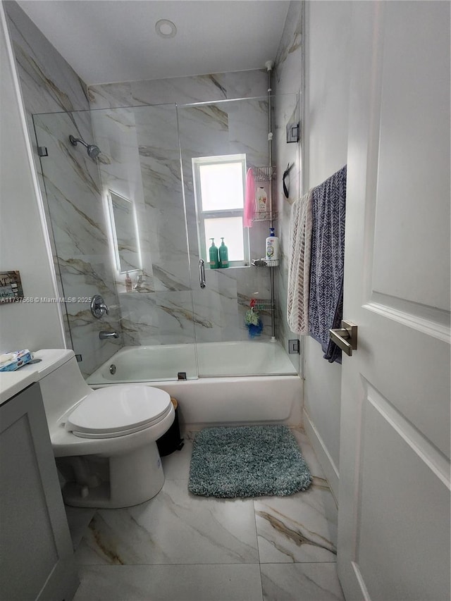 full bathroom with enclosed tub / shower combo, vanity, and toilet