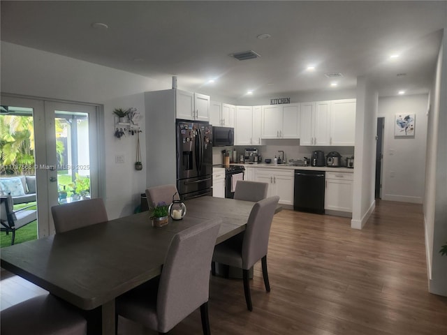 dining space with dark hardwood / wood-style flooring, sink, and french doors