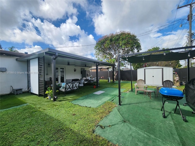 view of yard featuring a shed, outdoor lounge area, and a patio