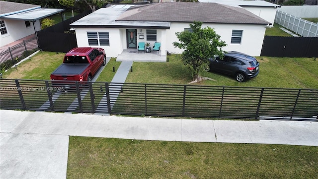 view of front of home with a patio area and a front lawn