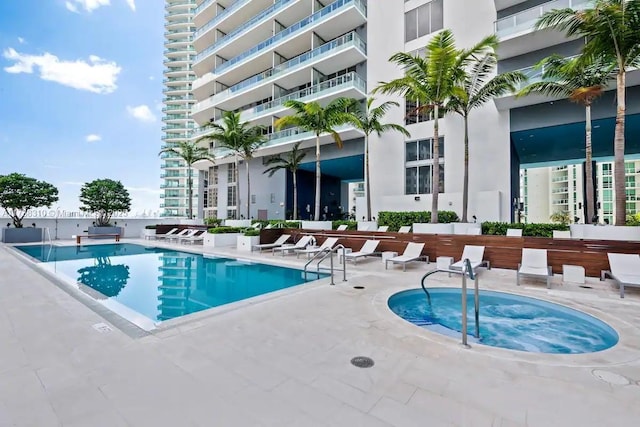 view of pool with a community hot tub and a patio