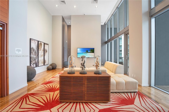 interior space with hardwood / wood-style flooring and a high ceiling