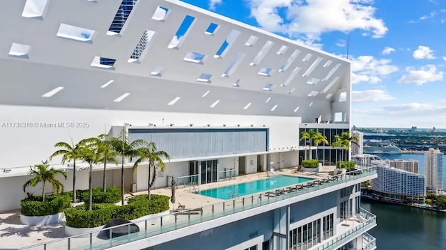 exterior space with a water view and a community pool