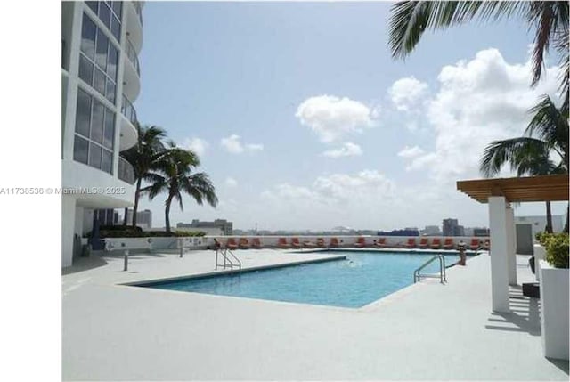 view of pool with a patio and a pergola