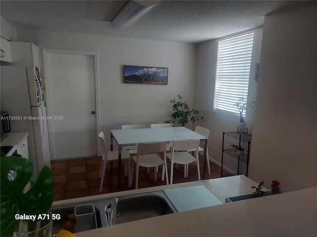 dining space featuring a textured ceiling