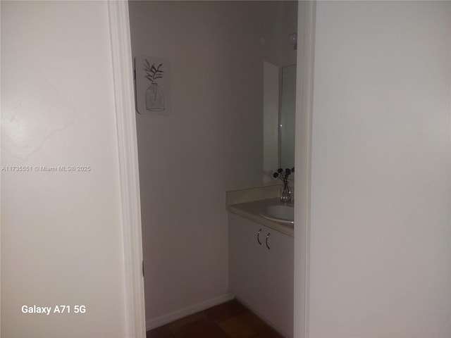 bathroom with vanity and baseboards