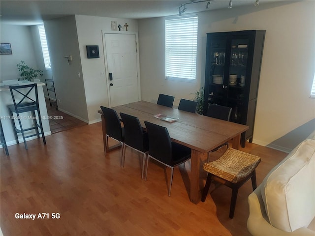 dining room featuring light wood-style flooring and baseboards