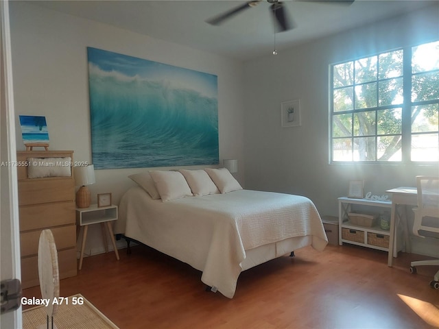 bedroom with ceiling fan and wood finished floors