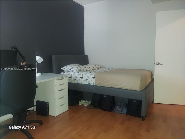 bedroom with wood finished floors