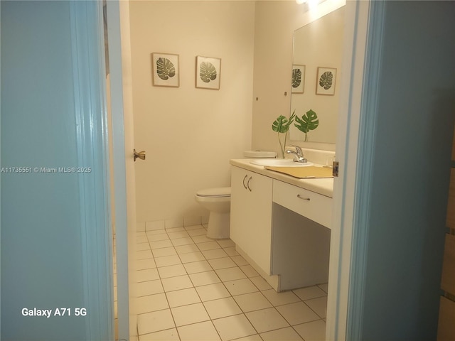 half bath with tile patterned flooring, vanity, and toilet