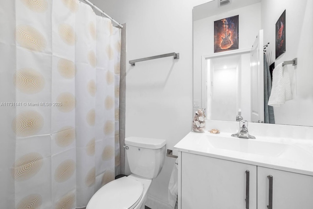 bathroom featuring vanity, curtained shower, and toilet