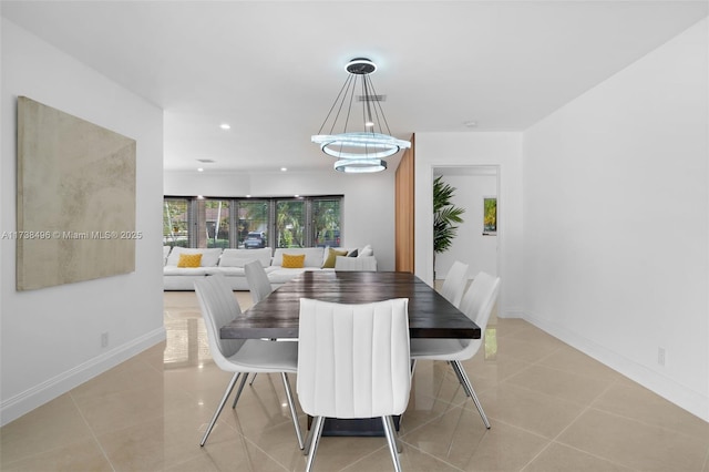 tiled dining space featuring an inviting chandelier