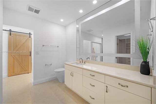 bathroom with vanity, toilet, and a shower with shower door