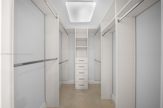 walk in closet featuring light tile patterned floors