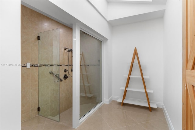 bathroom with tile patterned flooring and a shower with door